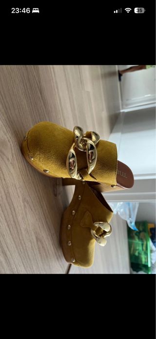 Zuecos amarillos con cadena dorada