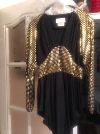 Blusón fiesta negro y oro,corte inglés