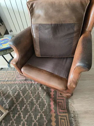Sillón orejero de cuero de gran dimensión.