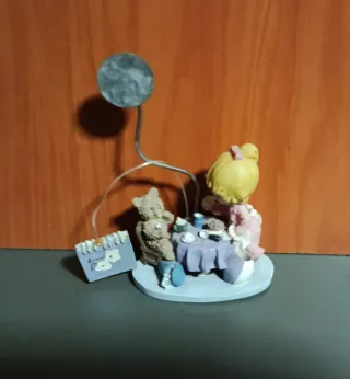 Figura niña y oso tomando té