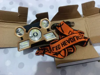 Linterna Frontal LED Dorada con Cinta Naranja