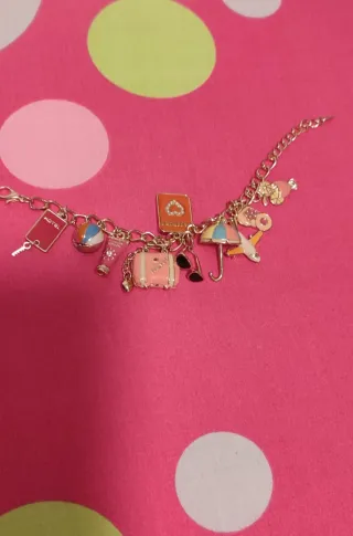 Pulsera dorada con charms de viaje sin estrenar