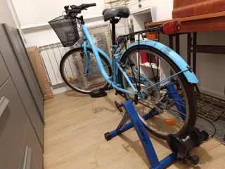 Bicicleta azul con rodillo y bomba