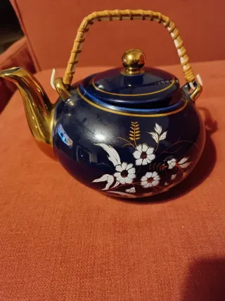 Tetera azul y dorada con asa de madera