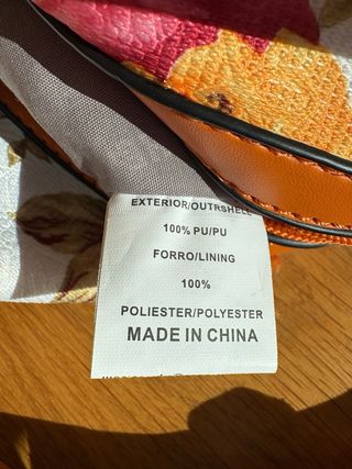 Bolso de mano floral con detalles naranjas