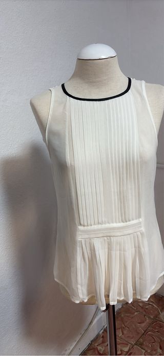 Blusa blanca sin mangas con plisados