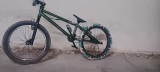 Bicicleta BMX verde con funda de rueda