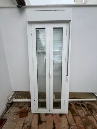 Puerta balconera blanca con persiana
