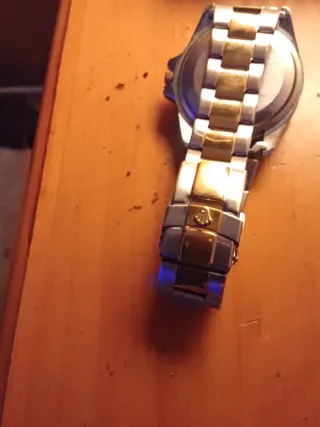 Reloj Rolex dorado y verde