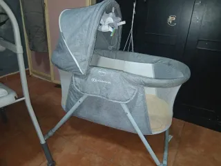 Cuna de bebé gris con colchoneta amarilla