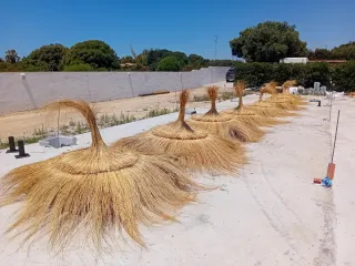 Pérgola y sombrillas de brezo y mimbre