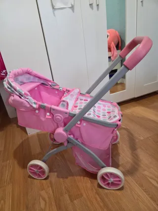 Carro de muñecas rosa.