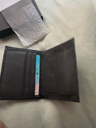 Cartera de piel negra con diseño texturizado