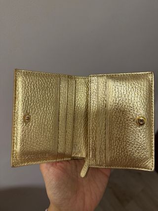 Cartera Coccinelle dorada cuero