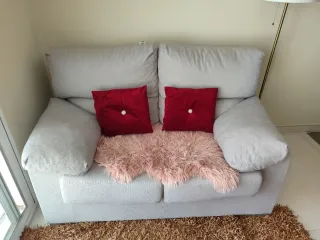 Sofá gris con cojines rojos