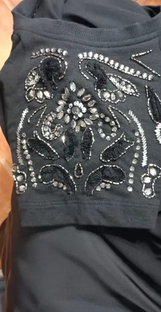 Blusa negra con pedrería y detalles plateados