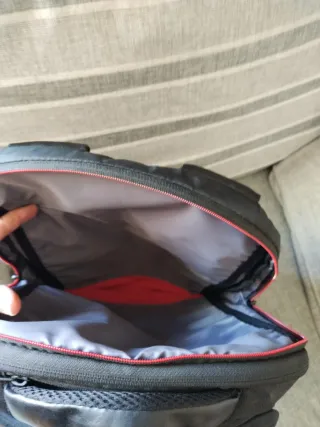 Mochila para portátil negra con detalles rojos.