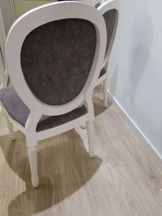 Sillas de madera blancas tapizadas en gris