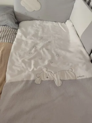 Cuna de bebé con diseño de osito y nubes