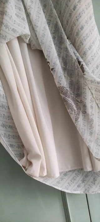 Vestido ligero verano beige con dibujo de flor.