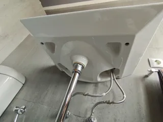 Lavabo suspendido de cerámica con grifo incluido.