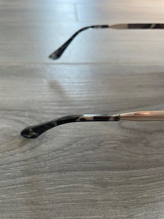 Gafas de sol grandes negras con patillas doradas