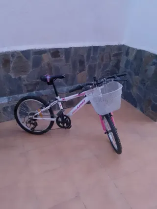 Bicicleta infantil blanca y rosa con cesta