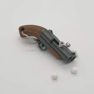 Llavero juguete disparador de bolitas