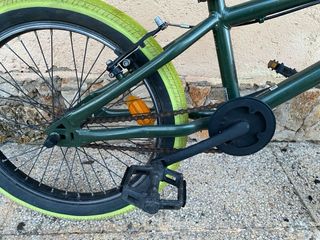 Bicicleta BMX verde con ruedas llamativas