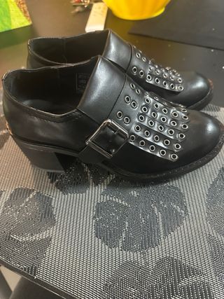 Scarpe nere con frange e borchie stile mocassino