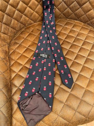 Corbata azul con escudo rojo