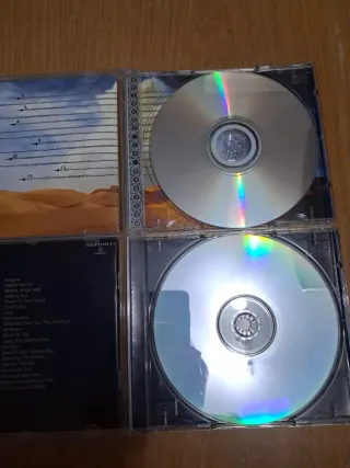 CDs John Lennon y The Rolling Stones