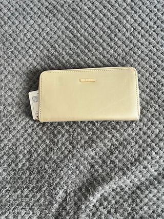 Cartera dorada con logo metálico