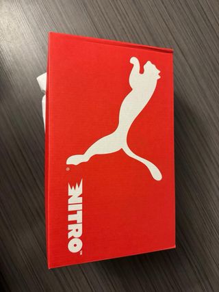 Zapatillas running Puma hombre blancas y naranjas