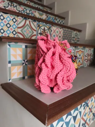 Bolso de mano rosa con cadena multicolor