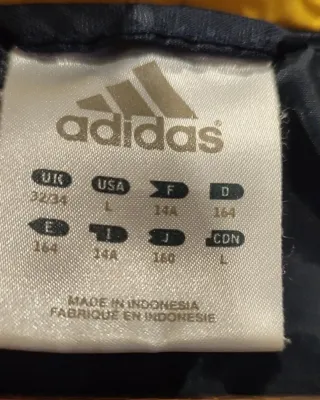 Chaqueta Adidas azul y dorada