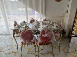 Mesa de cristal con juego de vajilla y sillas