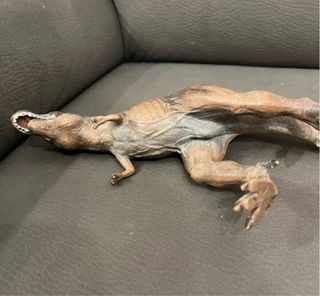 Dinosauro giocattolo marrone