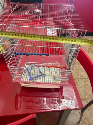 Jaula para pájaros roja y blanca