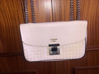 Bolso Guess rosa con detalles plateados.