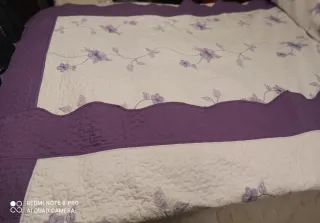 Colcha bouti morada y blanca con flores bordadas