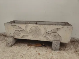 Jardinera de piedra con relieve floral