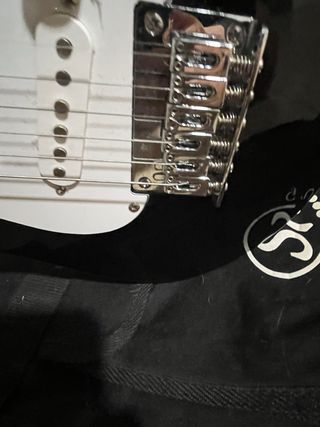 Guitarra eléctrica negra con amplificador