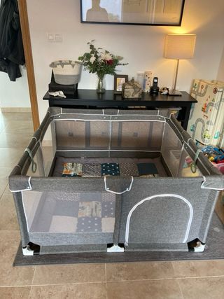 Parque infantil de tela gris, estructura de tubos