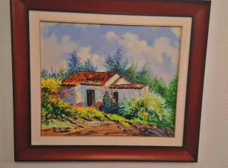 Cuadro de casa rural con marco de madera