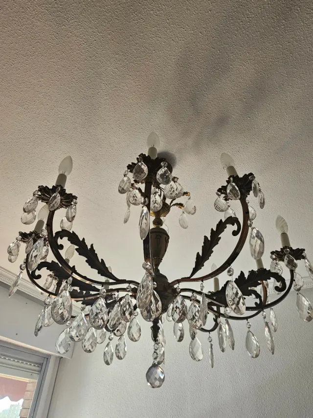 Lámpara de araña dorada con cristales.