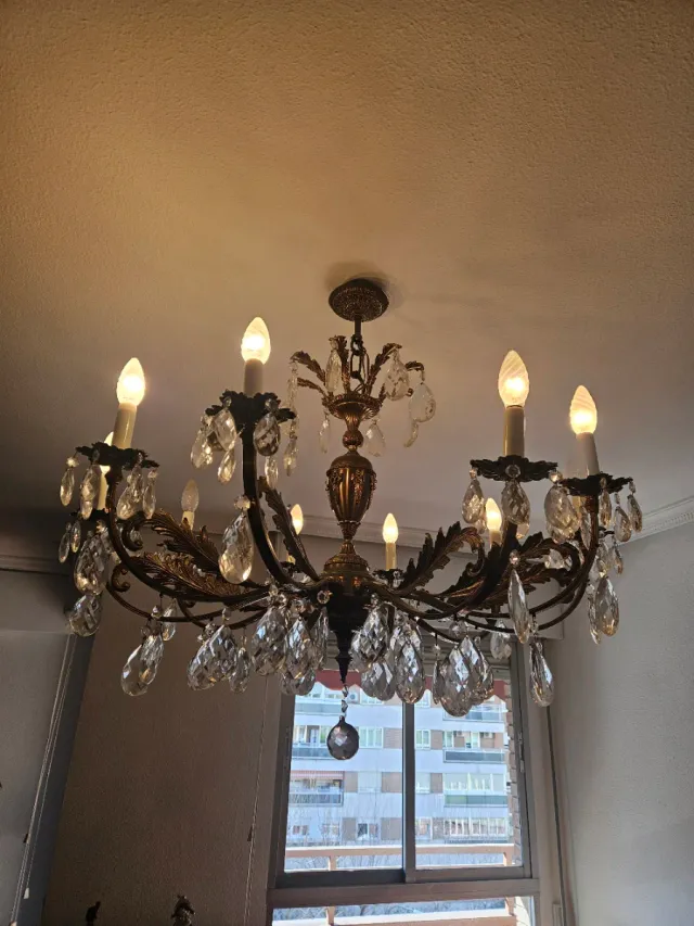 Lámpara de araña dorada con cristales.