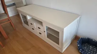 Mueble de salón blanco con puertas de cristal