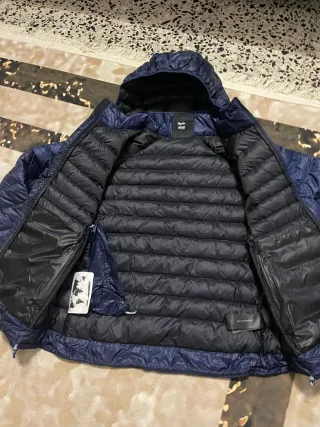 Chaqueta de plumas Rapha con capucha