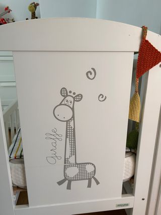 Cuna de bebé blanca con diseño de jirafa